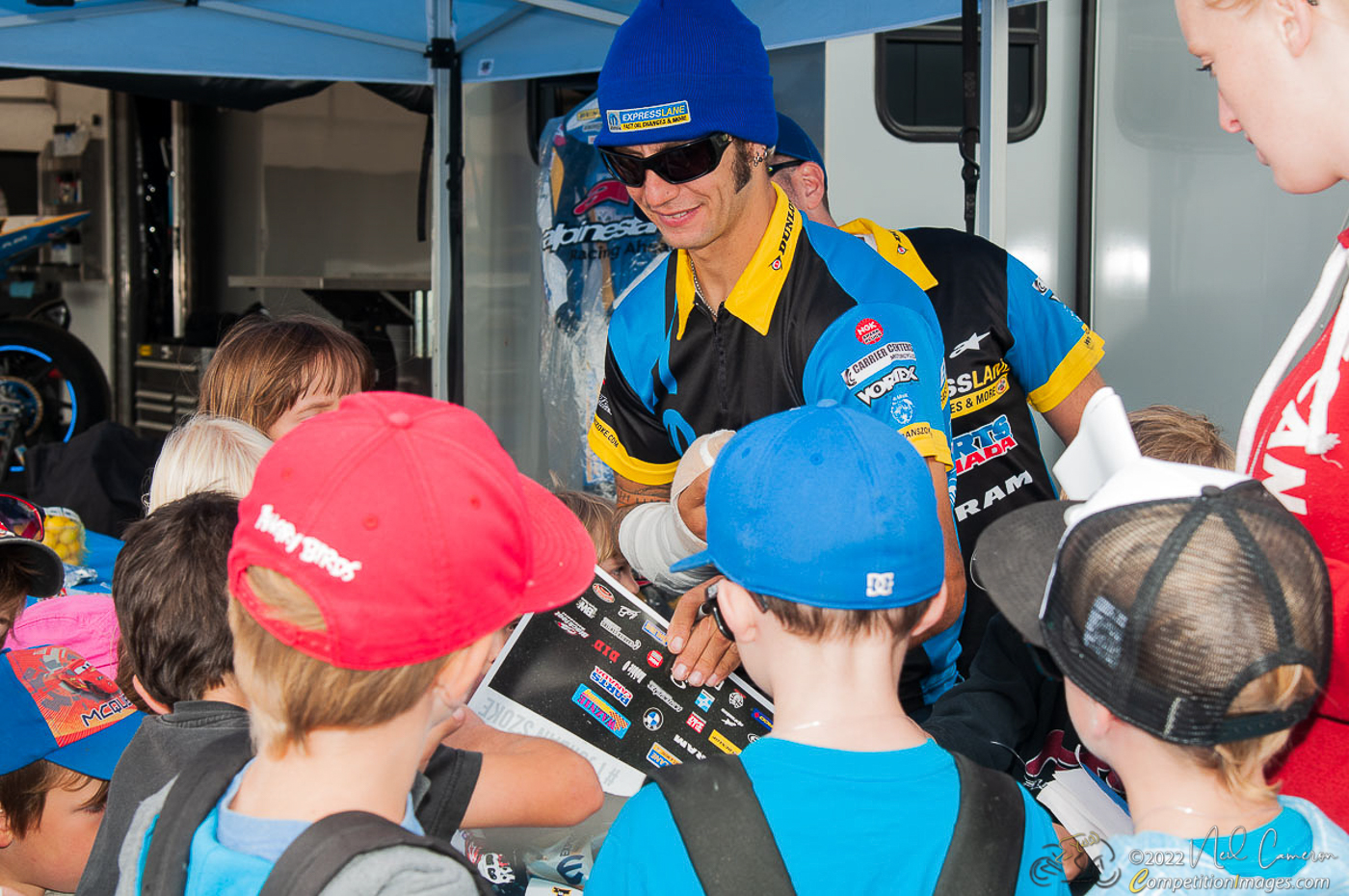 An injured Jordan Szoke signs autographs for kids at Mosport, August 2014